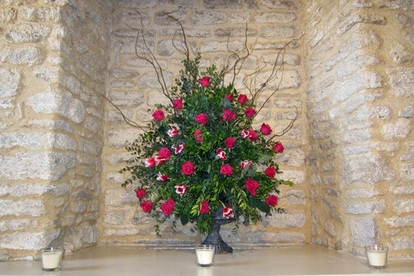 Wedding alcove arrangement featuring roses and tulips