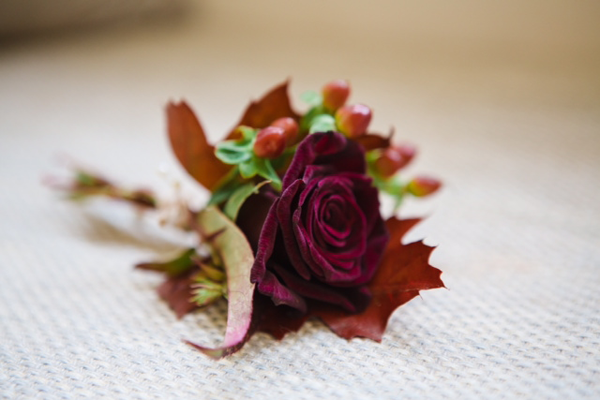 Winter wedding buttonhole with rose and berry detail