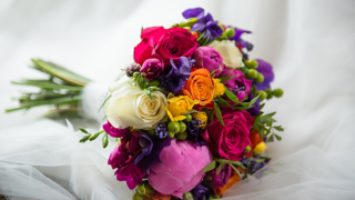 Bright and vibrant Brides bouquet including Roses, Peonies and Hypericum berries. Floral design by Cotswold Blooms, wedding florist based in Cheltenham.