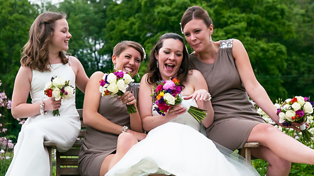 Bright and vibrant Brides and bridesmaids bouquet including Roses, Peonies and Hypericum berries. Floral design by Cotswold Blooms, wedding florist based in Cheltenham.