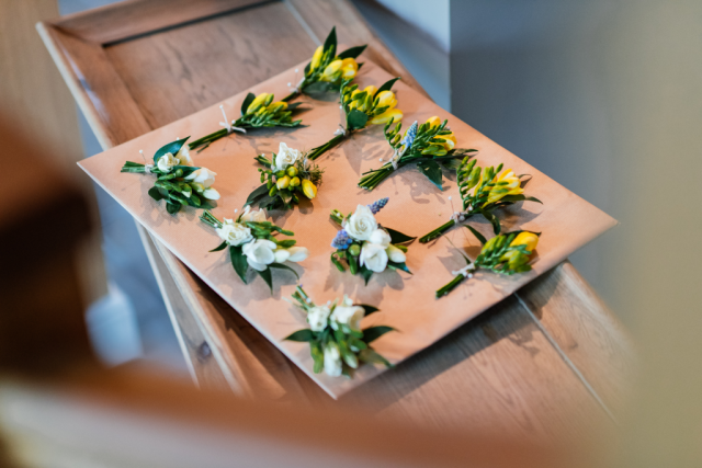 Yellow Freesia buttonholes and white Freesia corsages. Floral design by Cotswold Blooms, wedding florist based in Cheltenham.