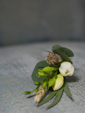 Freesia, Poppy head and mixed Eucalyptus buttonhole. Floral design by Cotswold Blooms, wedding florist based in Cheltenham.