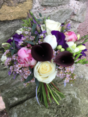 Hand tied bouquet including Calla Lily, Peonies, Roses and Waxflower. Floral design by Cotswold Blooms, wedding florist based in Cheltenham.