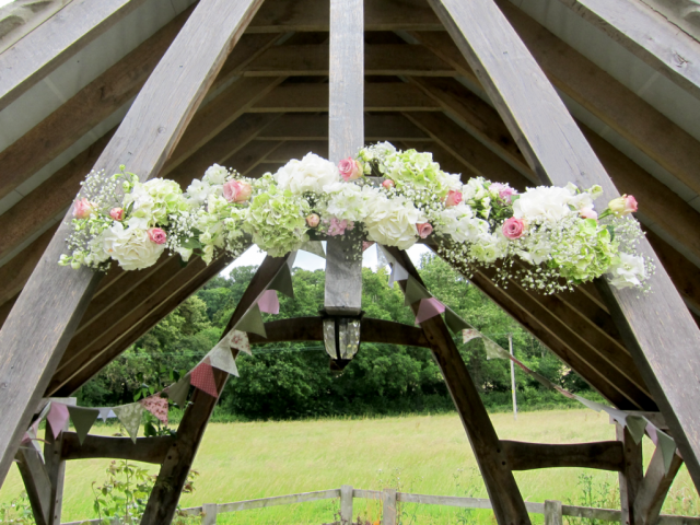 Hydrangea, Rose and Gypsophila arbour display at Hyde House, Stow-on-the-Wold. Floral design by Cotswold Blooms, wedding florist based in Cheltenham.