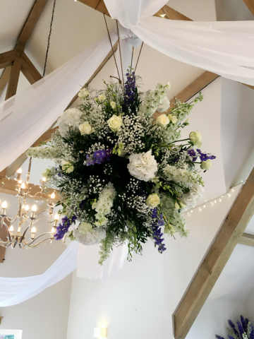 Hyde Barn hanging flower ball with white and blue Hydrangea, Delphinium and Rose displays. Floral design by Cotswold Blooms, wedding florist based in Cheltenham.