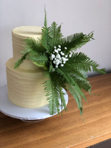 Fern spray display on a 2 tiered wedding cake. Floral design by Cotswold Blooms, wedding florist based in Cheltenham.