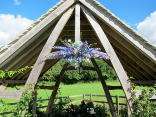 Delphinium spray display in shades of blues and purple. Floral design by Cotswold Blooms, wedding florist based in Cheltenham.