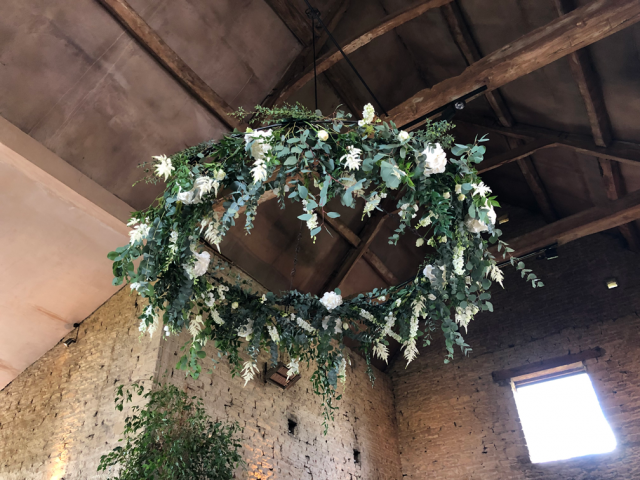Halo of mixed foliage and white flowers hanging at Cripps Barn. Floral design by Cotswold Blooms, wedding florist based in Cheltenham.