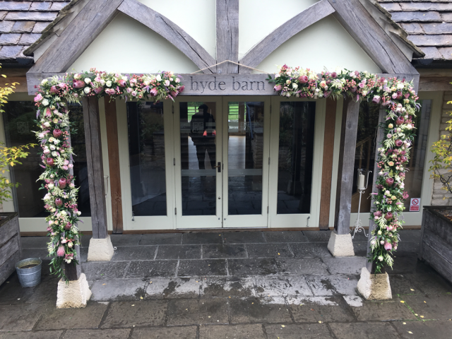 Entrance Display at Hyde House including Protea, Astilbe, Roses and Hypericum. Floral design by Cotswold Blooms, wedding florist based in Cheltenham.