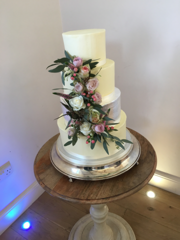 Flower display down an elegant wedding cake. Floral design by Cotswold Blooms, wedding florist based in Cheltenham.
