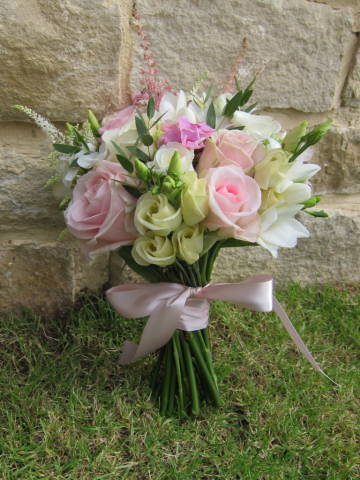 Hand tied bridesmaid bouquet in light pink and white. Floral design by Cotswold Blooms, wedding florist based in Cheltenham.