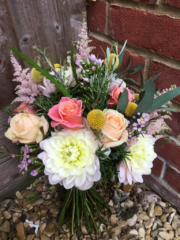 Coral, peach and light pink natural brides bouquet. Floral design by Cotswold Blooms, wedding florist based in Cheltenham.