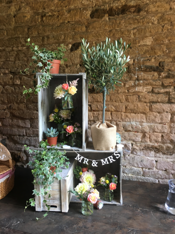 Crate display to welcome wedding guests at Stanway Fountain. Floral design by Cotswold Blooms, wedding florist based in Cheltenham.