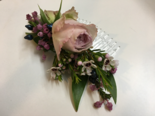 Roses, Waxflower and heather hair slides. Floral design by Cotswold Blooms, wedding florist based in Cheltenham.