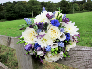 White, blue and purple Roses, Eustoma, Corn Flower and Muscari . Floral design by Cotswold Blooms, wedding florist based in Cheltenham.