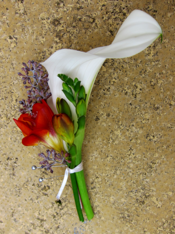 Calla Lily with red Freesia and Sedum. Floral design by Cotswold Blooms, wedding florist based in Cheltenham.