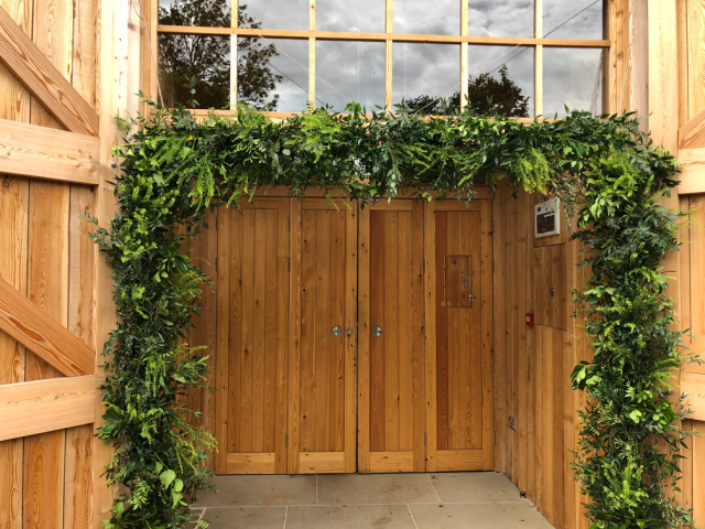 Mixed Foliage framing the entrance to the Grange Hyde House.  Floral design by Cotswold Blooms, wedding florist based in Cheltenham.