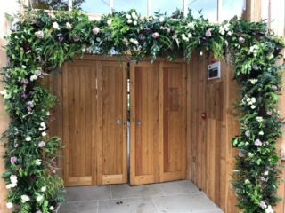 Mixed foliage with burgundy, light pink and white flower detail including Roses, Heather, Safari and Ornithogalum at the Grange Hyde House. Floral design by Cotswold Blooms, wedding florist based in Cheltenham.