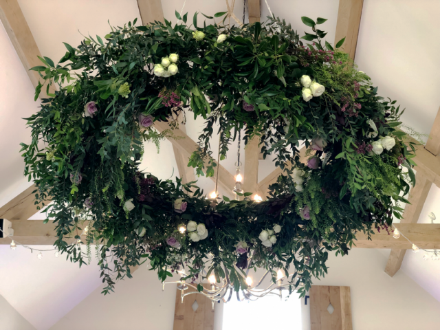 Halo mixed foliage with burgundy, light pink and white flower detail including Roses, Heather, Safari and Ornithogalum at Hyde House. Floral design by Cotswold Blooms, wedding florist based in Cheltenham.