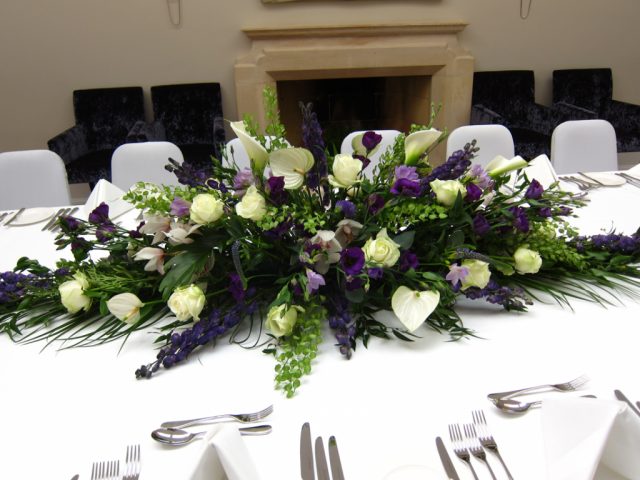 - Purple, white and green including Roses, Orchids, Anthurium and lush green foliage at Foxhill Manor. Floral design by Cotswold Blooms, wedding florist based in Cheltenham.