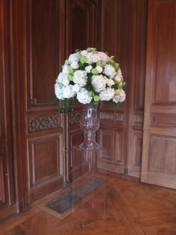Glass urn display of Hydrangea, Roses and Guelder Rose in lime green and fresh white at Cowley Manor. Floral design by Cotswold Blooms, wedding florist based in Cheltenham.