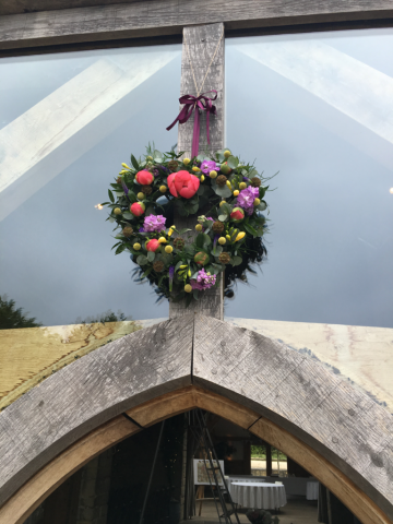 Floral heart hanging at Cripps Barn. Floral design by Cotswold Blooms, wedding florist based in Cheltenham.