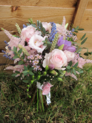 Country garden hand tied bouquet in light pink with touches purple including Roses, Wax flower and Muscari. Floral design by Cotswold Blooms, wedding florist based in Cheltenham.