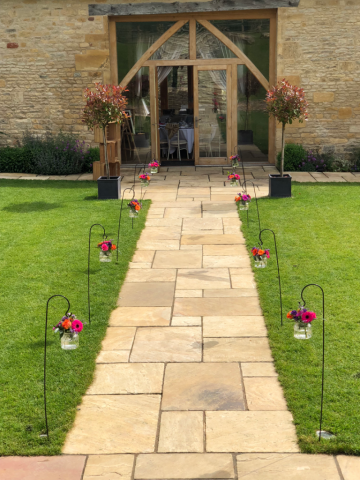 Sheppard’s hooks with hanging displays at the entrance to the Barn at Upcote. Floral design by Cotswold Blooms, wedding florist based in Cheltenham.