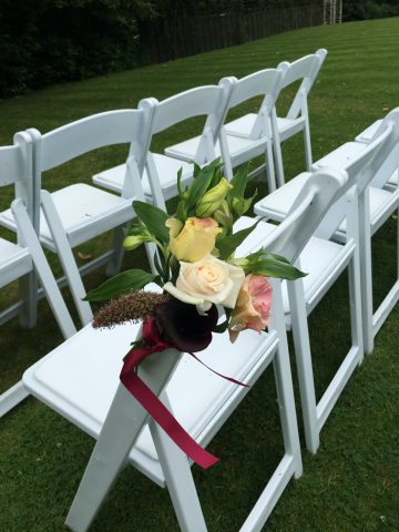 Rose, Calla lily and Alstroemeria aisle markers at Manor by the Lake, Cheltenham. Floral design by Cotswold Blooms, wedding florist based in Cheltenham.