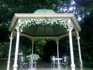 Arch display in white and blue at Manor by the Lake. Floral design by Cotswold Blooms, wedding florist based in Cheltenham.