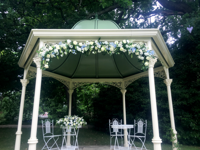 Arch display in white and blue at Manor by the Lake. Floral design by Cotswold Blooms, wedding florist based in Cheltenham.