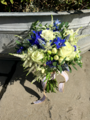 White and blue including Delphinium, Roses, Freesia and a touch of foliage. Floral design by Cotswold Blooms, wedding florist based in Cheltenham.