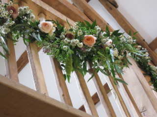 Natural country garden hanging display on the gallery at Thyme Southrop, including Astrantia, Daisy and country garden Roses. Floral design by Cotswold Blooms, wedding florist based in Cheltenham.