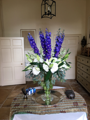 Urn display of white Hydrangea, blue Delphinium and Lily with Populus. Floral design by Cotswold Blooms, wedding florist based in Cheltenham.
