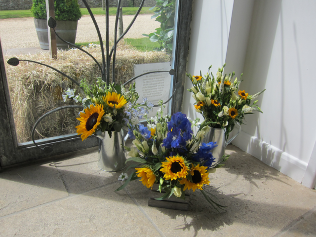 Natural displays including Sunflowers at Cripps Stone Barn. Floral design by Cotswold Blooms, wedding florist based in Cheltenham.