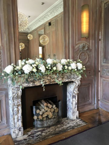 Hydrangea, Roses, and mixed foliage mantel piece display at Cowley Manor. Floral design by Cotswold Blooms, wedding florist based in Cheltenham.