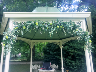 Natural foliage display with touches of Snow Berries, Pussy Willow and lime green Eustoma. Floral design by Cotswold Blooms, wedding florist based in Cheltenham.