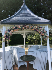 Peach, blue, light pink Roses, Agapanthus, Delphinium and Eucalyptus at Hockwold Hall. Floral design by Cotswold Blooms, wedding florist based in Cheltenham.