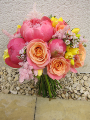 Bright coral bouquet of Peonies, Roses, Freesia. Floral design by Cotswold Blooms, wedding florist based in Cheltenham.