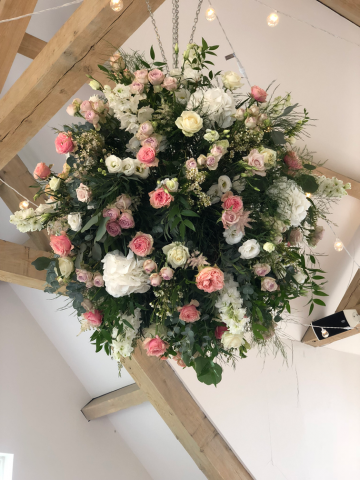 Flower ball of Roses, Delphinium, Hydrangea, wax flower and mixed foliage hanging at Hyde house. Floral design by Cotswold Blooms, wedding florist based in Cheltenham.