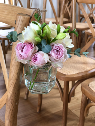 Spray Roses, Freesia and Eucalyptus in a hanging jar aisle marker at the Grange Hyde House. Floral design by Cotswold Blooms, wedding florist based in Cheltenham.