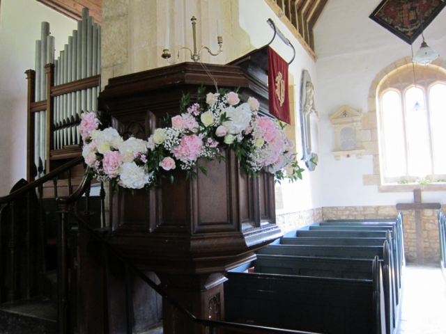 Light pink Hydrangea, Eustoma and Roses on the pulpit for a church wedding. Floral design by Cotswold Blooms, wedding florist based in Cheltenham.