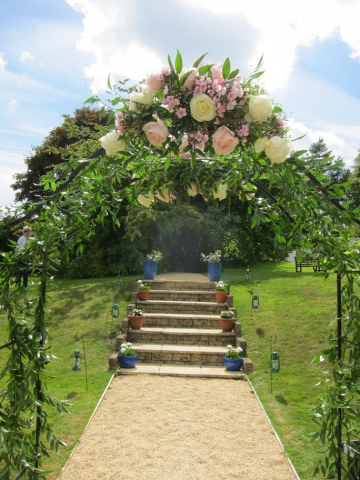 Garden arch display in light pink and white. Floral design by Cotswold Blooms, wedding florist based in Cheltenham.