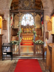 Church display in white, dusky and light pink including Roses, Gypsophila, freesia at How Caple Court. Floral design by Cotswold Blooms, wedding florist based in Cheltenham.
