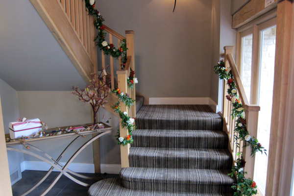 Garlands to decorate the stairs at Hyde House, Stow-on-the-Wold. Floral design by Cotswold Blooms, wedding florist based in Cheltenham.