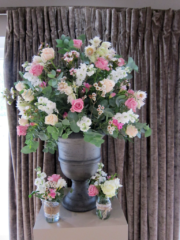 Urn display with jar displays including Roses, Delphinium, Waxflower and Freesia. Floral design by Cotswold Blooms, wedding florist based in Cheltenham.