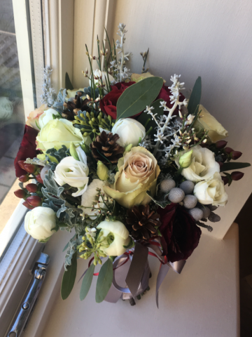 Winter bouquet with pine cone and Brunia detail. Floral design by Cotswold Blooms, wedding florist based in Cheltenham.