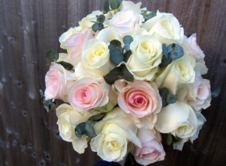 White and light pink Roses with a touch of Eucalyptus creating this classic brides bouquet. Floral design by Cotswold Blooms, wedding florist based in Cheltenham.