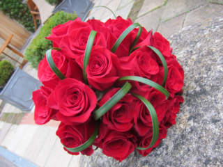 Red Rose bouquet with Lily grass detail. Floral design by Cotswold Blooms, wedding florist based in Cheltenham.