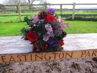 Winter wedding bouquet in red, purple and lilac. Floral design by Cotswold Blooms, wedding florist based in Cheltenham.